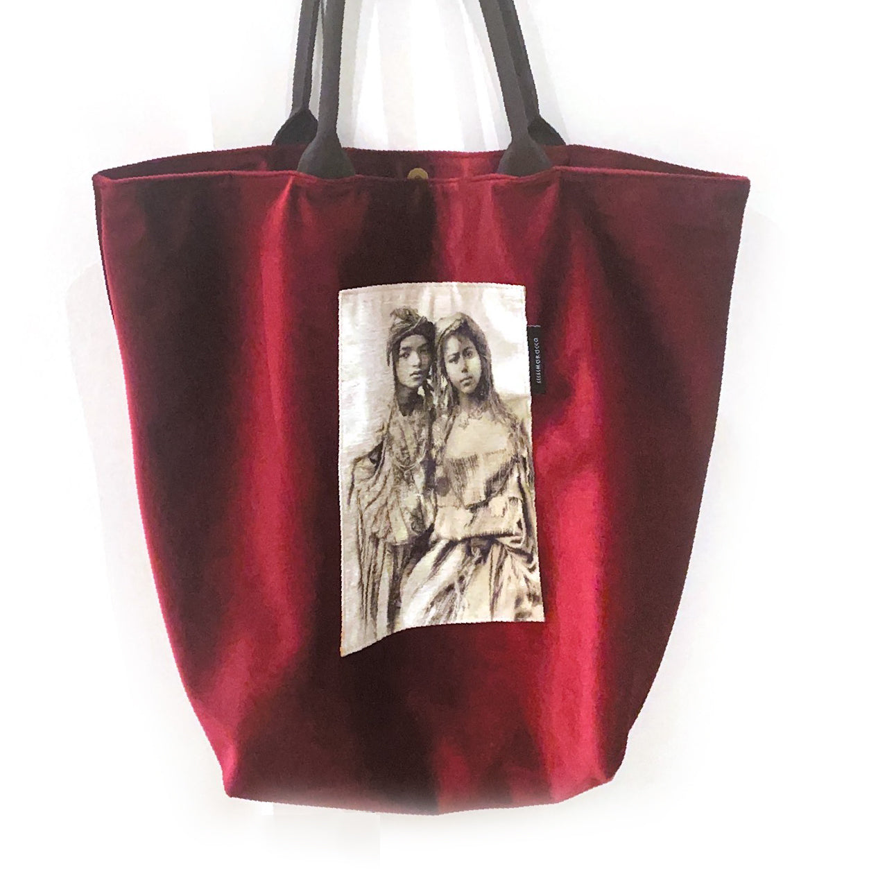 Red velvet Tout bag with a picture on it, the picture is on white background. grayscale picture of two girls.