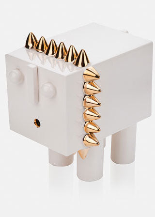 White abstract lion statue with golden mane.