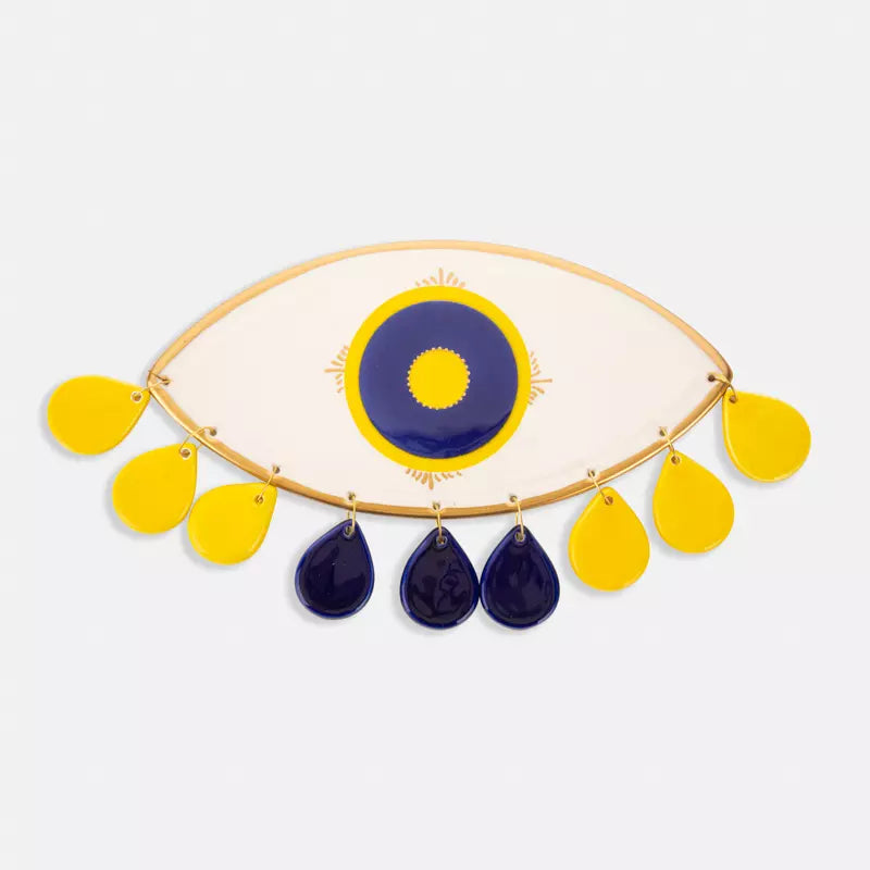 Beige ceramic eye sconce with yellow tears pendant