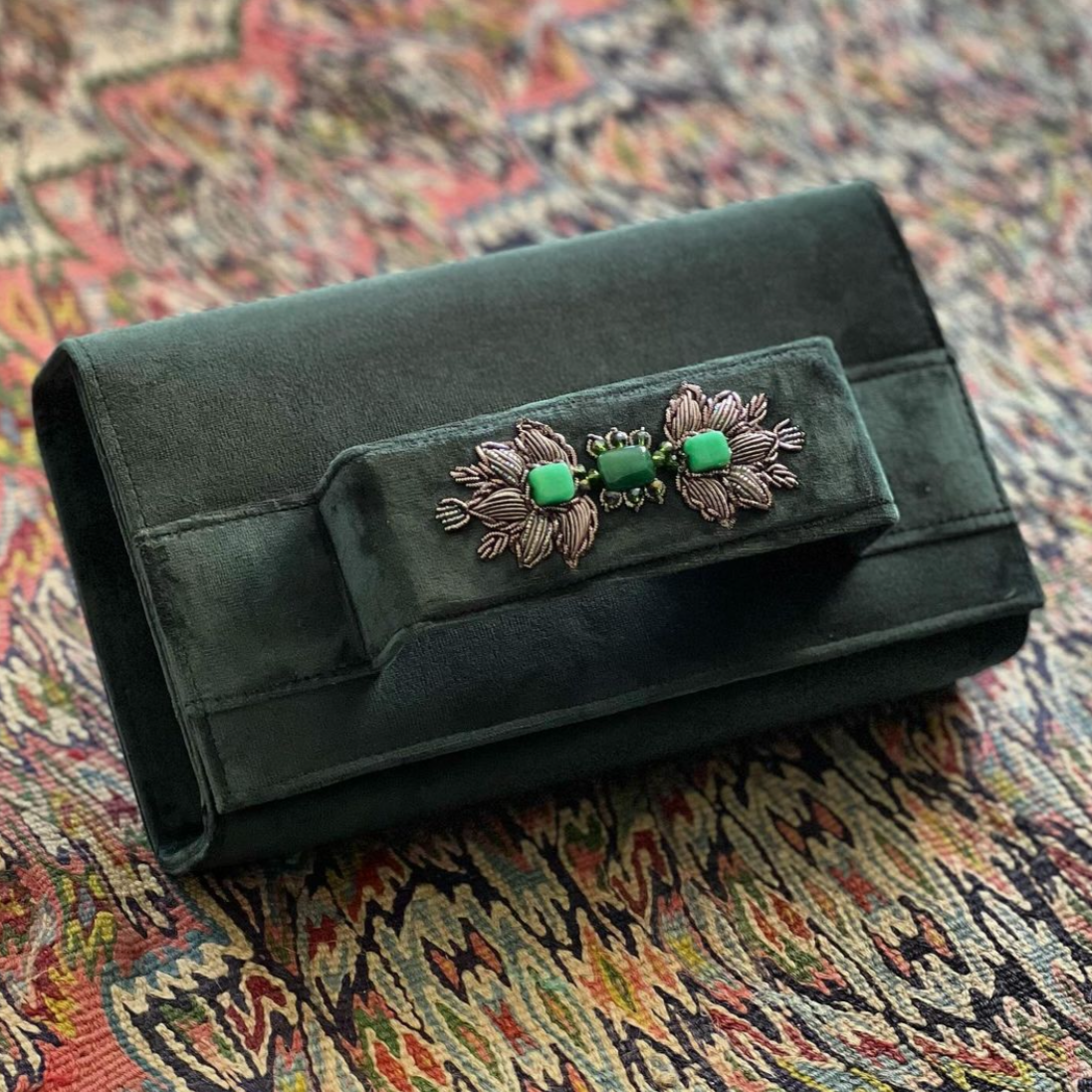 Dark green clutch with embroidery and beads.