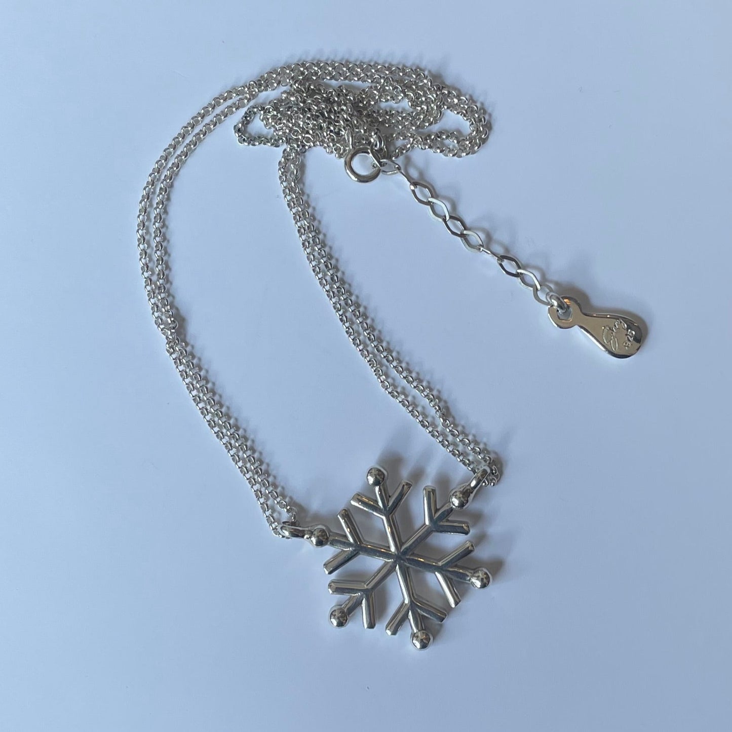 Silver necklace with double thin chain and snow design.