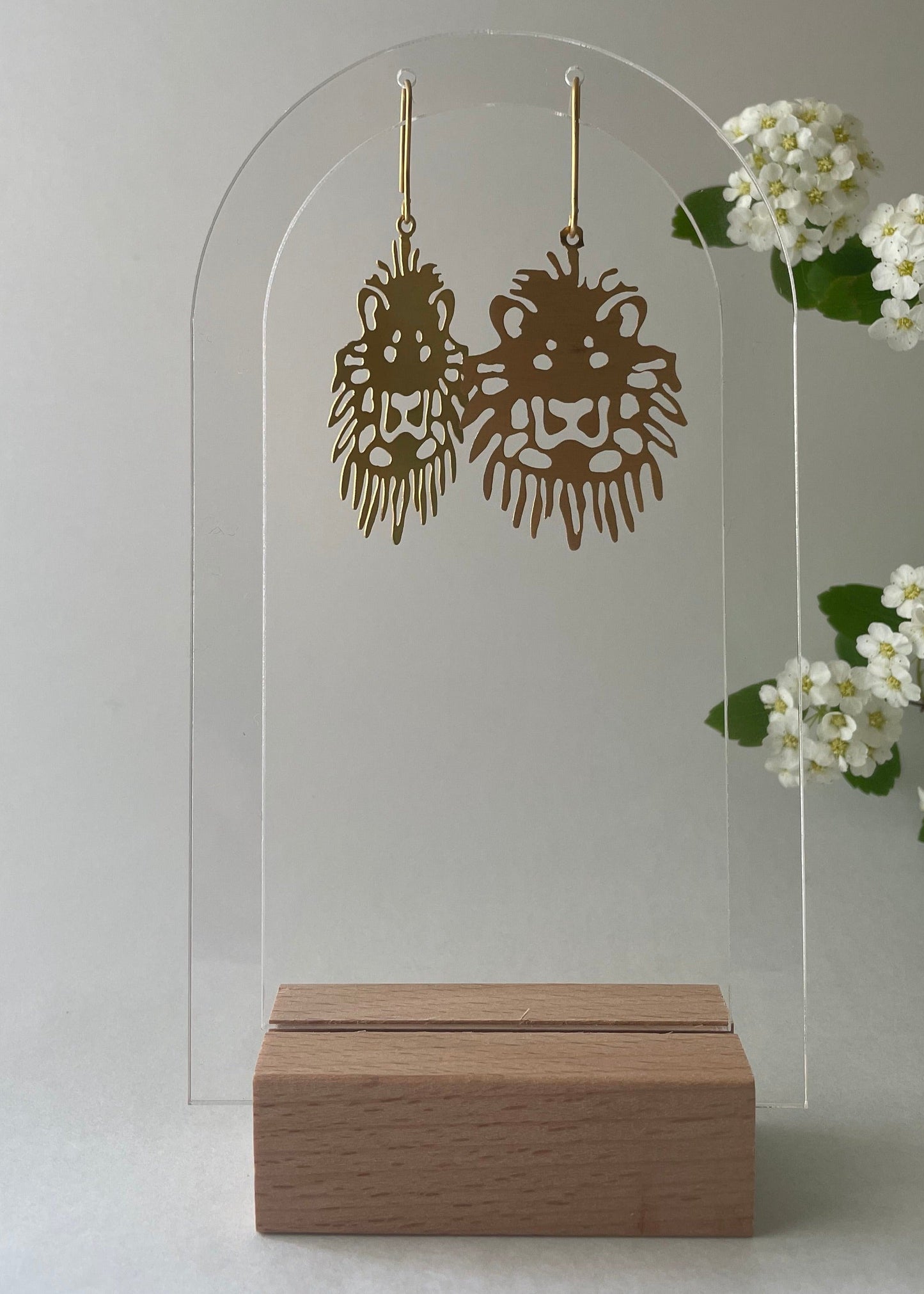 Flat earrings in the shape of lion.