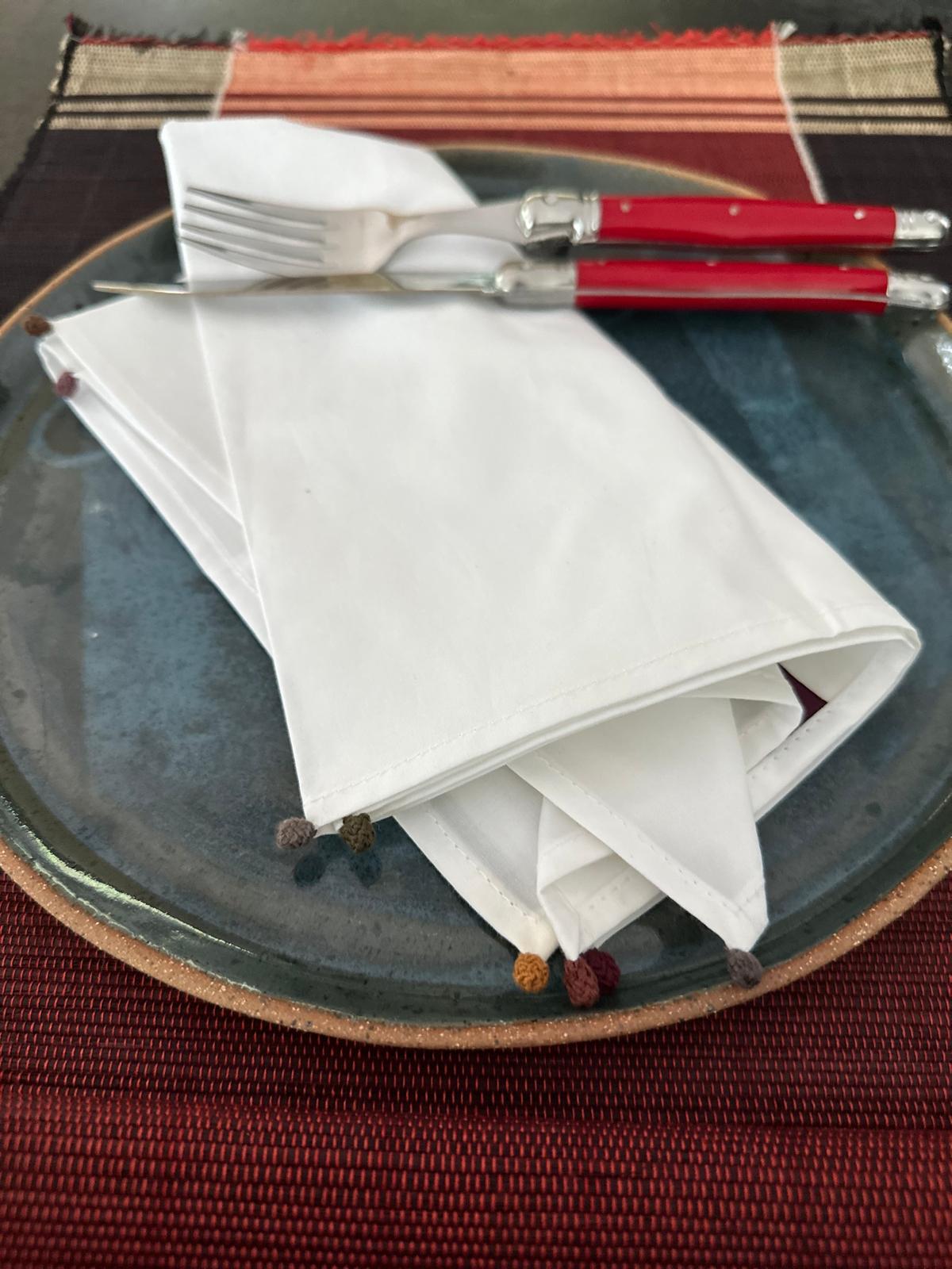 The napkin under a plate on a table