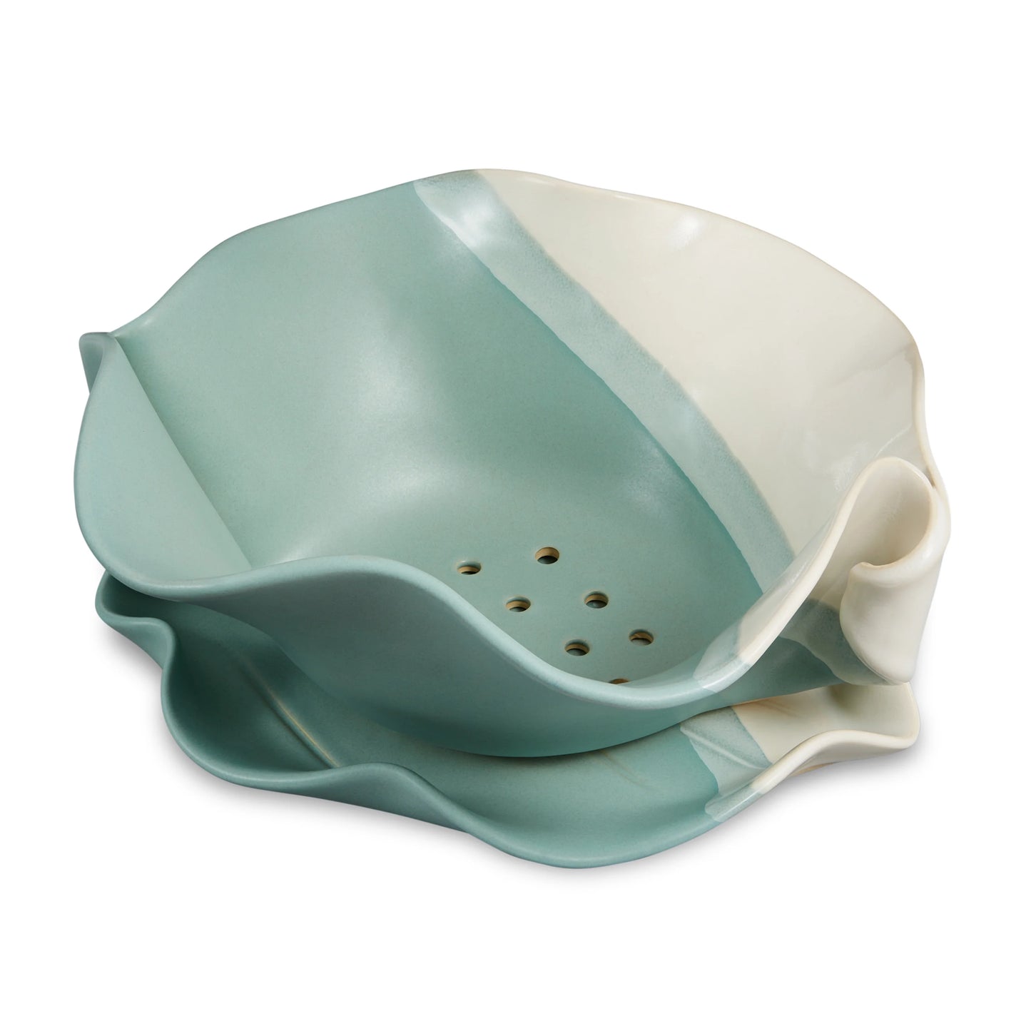 Irregular beige and green ceramic bowl with holes on the bottom.