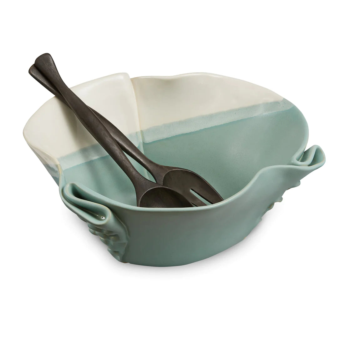 Irregular green and beige ceramic bowl with texture in outside of the bowl and black wooden spoon and fork.