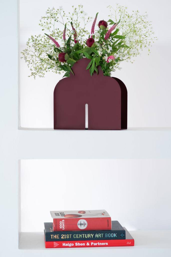 The vase on a shelf.