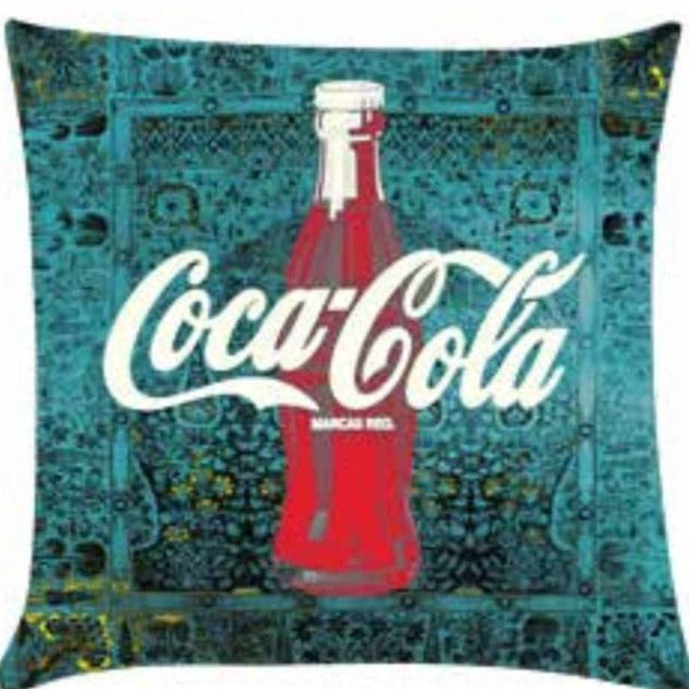 cushion with green pattern in background and Coca Cola design in center.