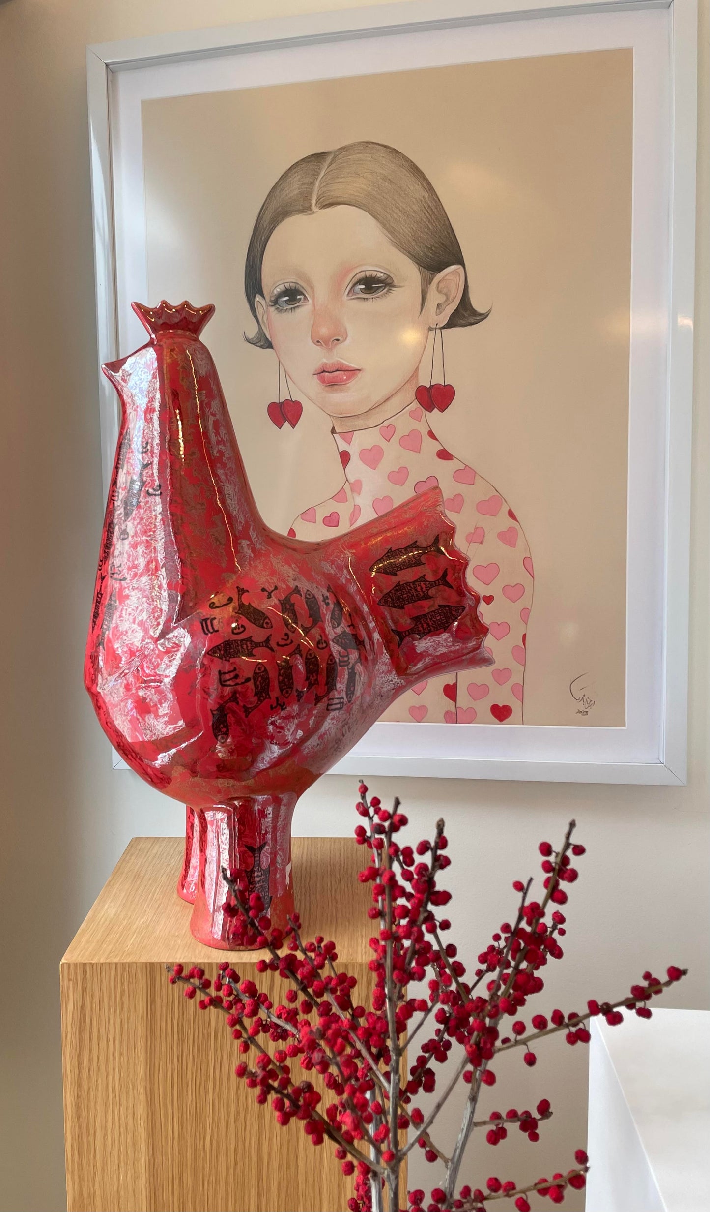 Red bird statue on stand.