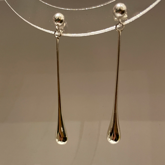 long silver earrings like a blob dropping.