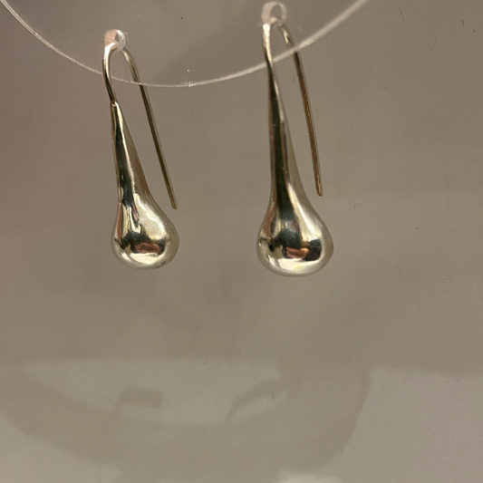 Silver earrings like a blob dropping.