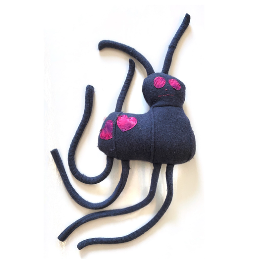 Dark blue animal with two pink hearts.