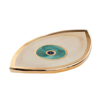 Beige ceramic plate in the shape of eye with golden edge and eye design on the center.