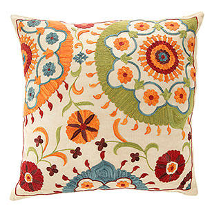 white silk cushion with flowers embroidered.