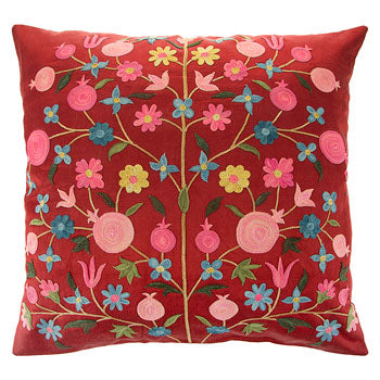 red  silk cushion with flowers embroidered.