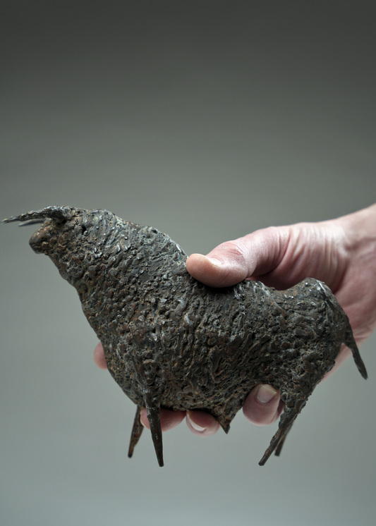 The sculpture held in hand.
