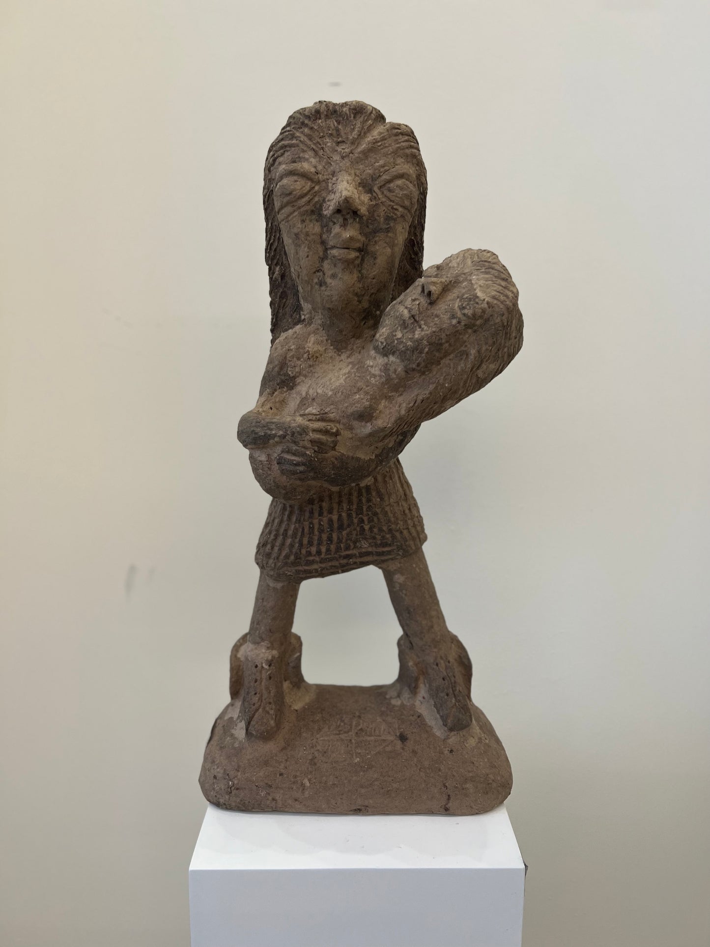 Papier Mache Sculpture; a mother holds her baby in her arms.