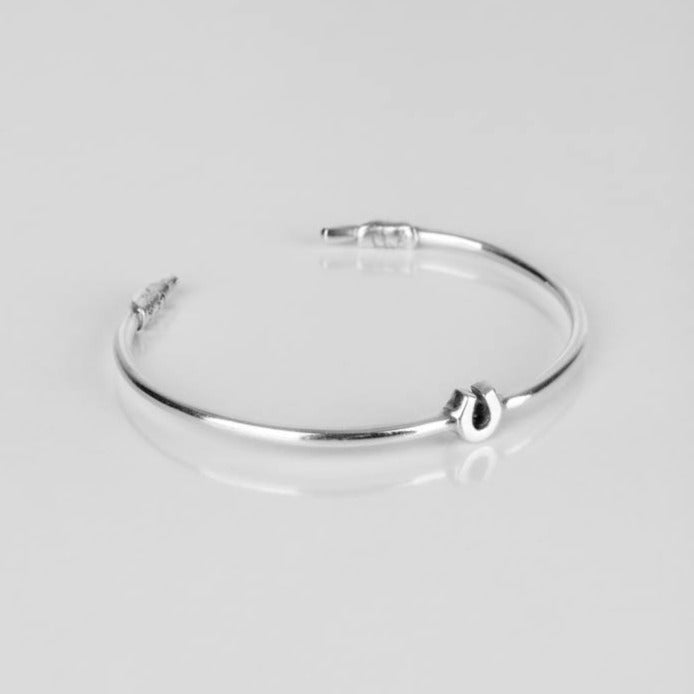 Silver cuff with little horseshoe on it