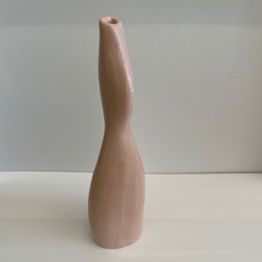 Tall & Thin ceramic vase with light pink glaze and asymmetric shape.
