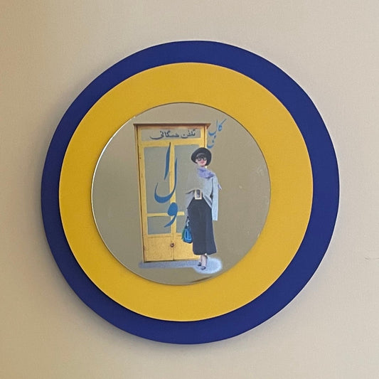 Two concentric wooden circle, the biggest one in dark blue color and the small one in yellow color. and a mirror in smaller size in the center.