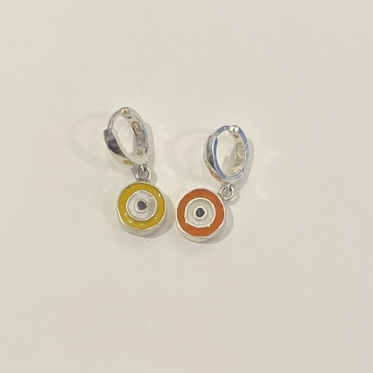 Earrings with eye design, one of them is yellow and other one is orange.