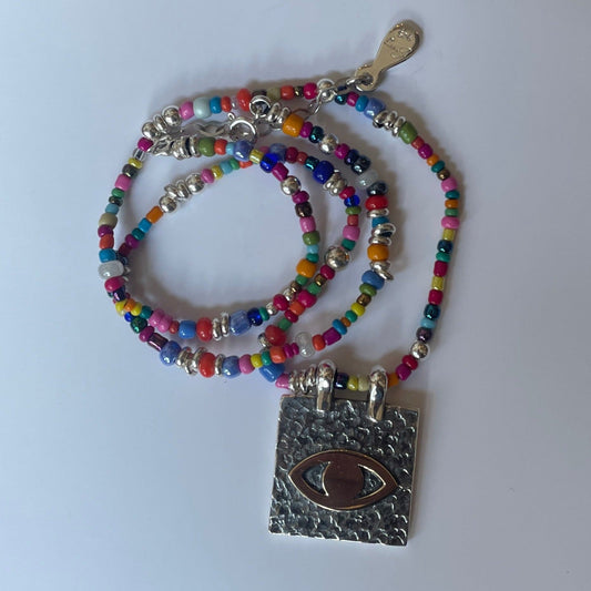 Silver Square with eye design and bead pendant.