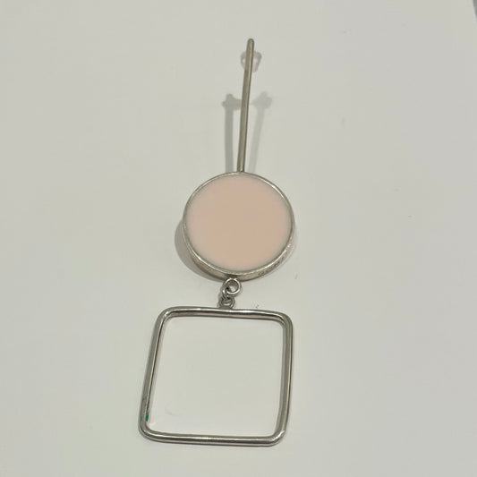 Earring formed by hole square in the bottom and a circle which filed with light pink epoxy resin.