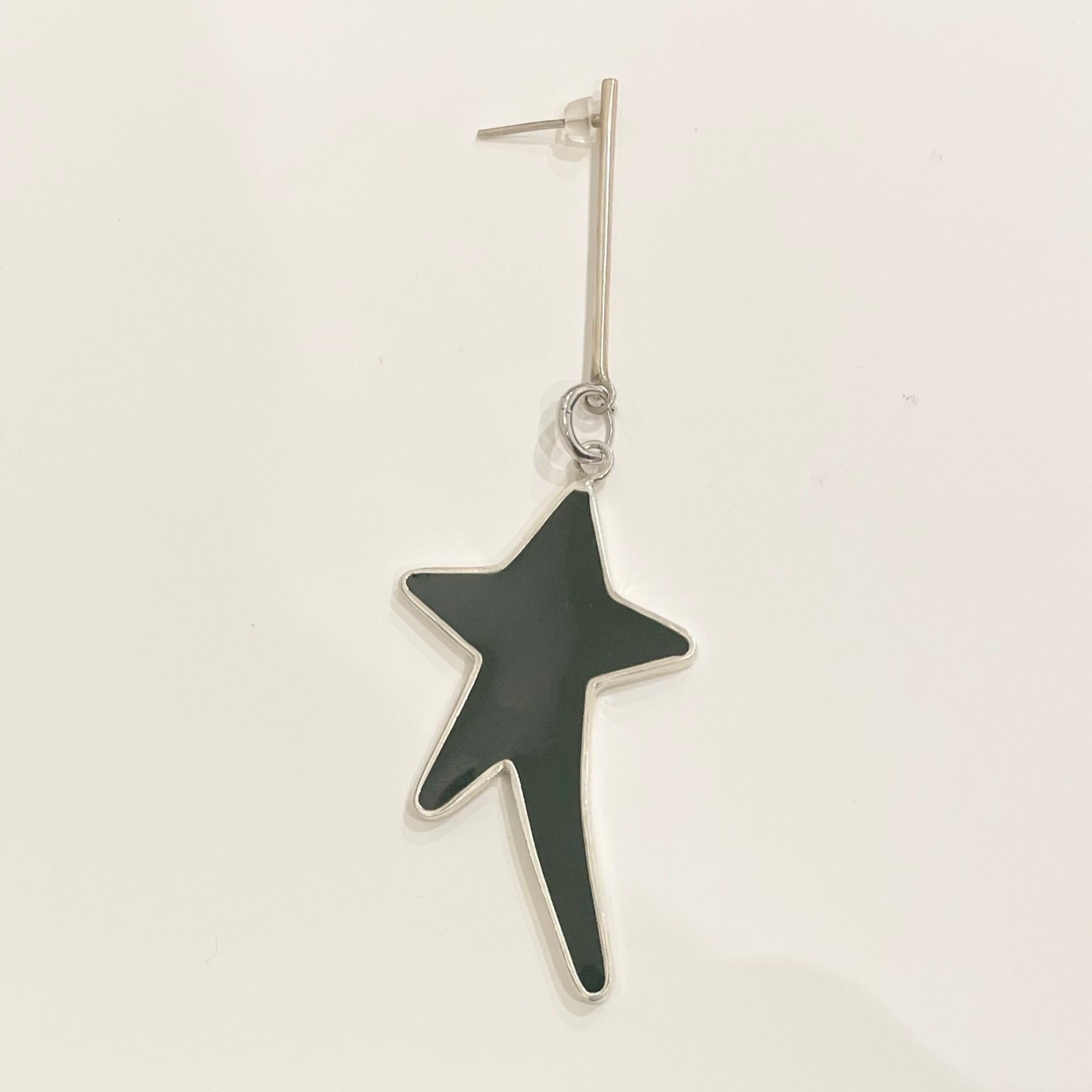 Star silver earring filed with black epoxy resin with long stem.