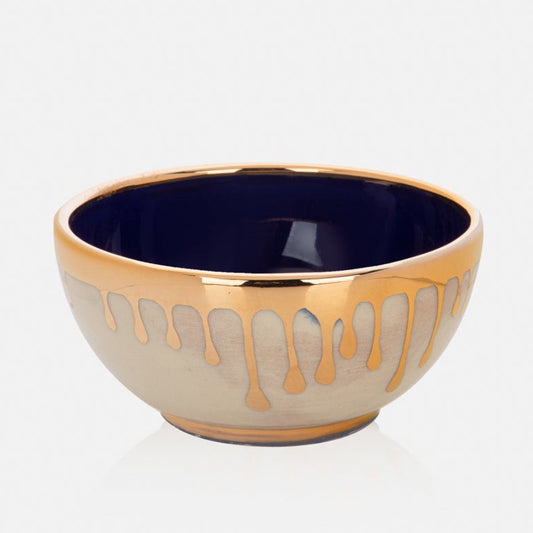 Outside the bowl is beige and inside is dark blue. edge of the bowl is golden.