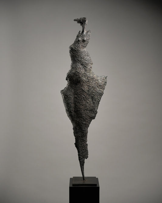 Minimal steel sculpture in shape of a woman in the wind.