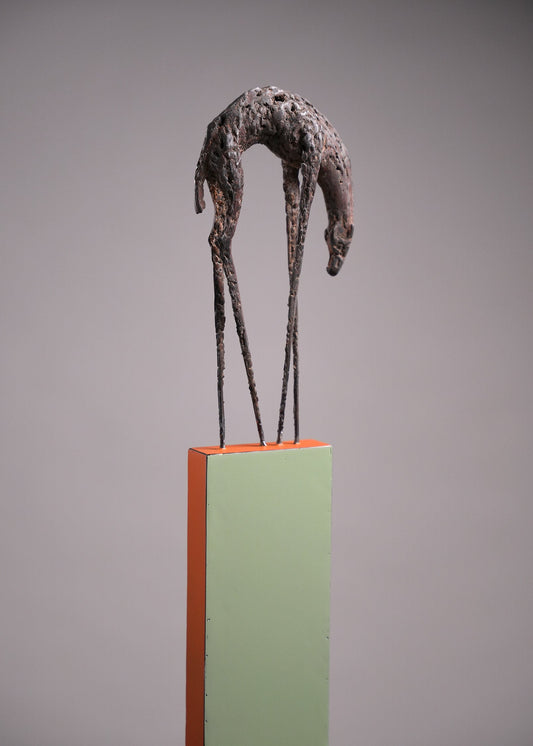 Steel sculpture on a stand; a hunchback animal with long and thin feet.