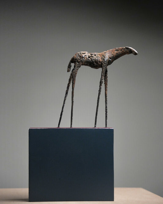 Steel animal sculpture with thin feet.