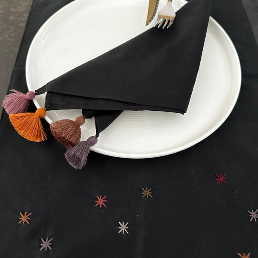 Black napkin with tassel on corners