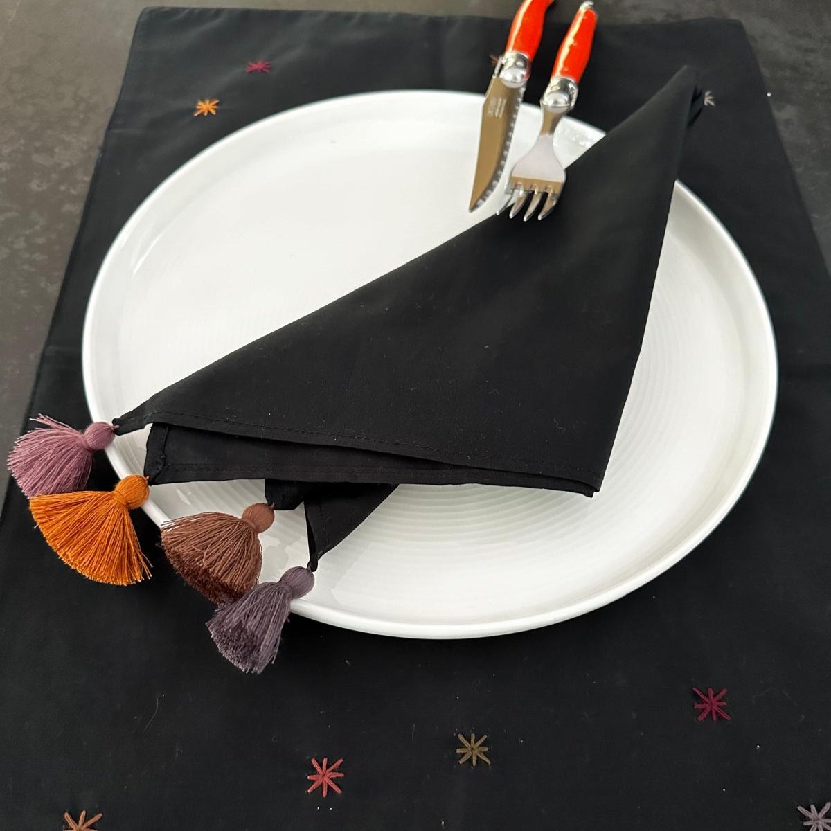 Black napkin with stars embroidered on it