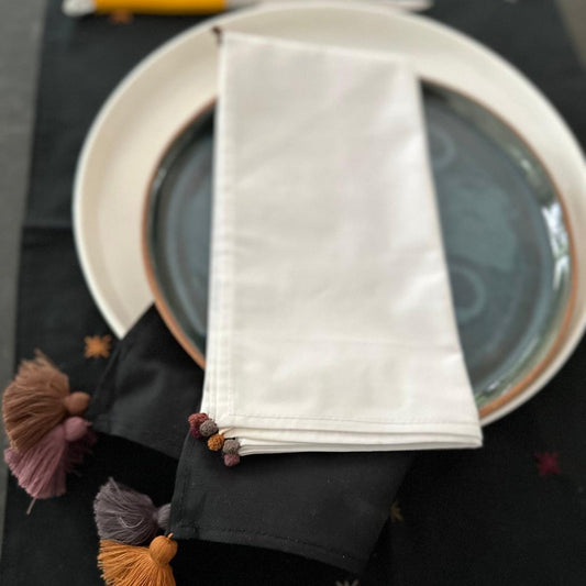 white napkin with little embroidery on edges.