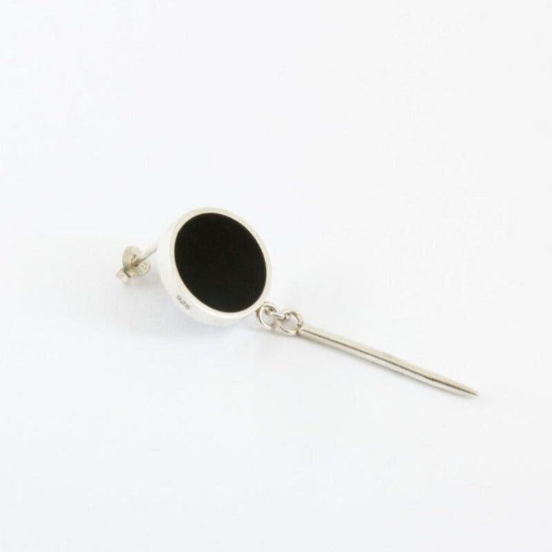 Round silver earring filed with black epoxy resin with long stem.