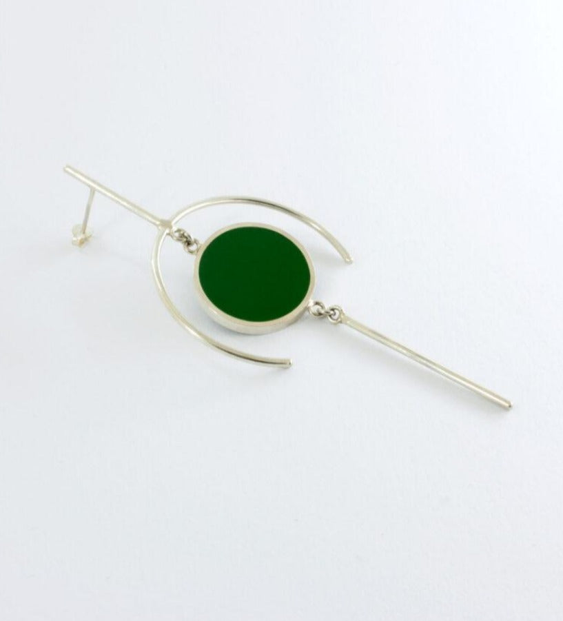 Geometric earring with circle filled with dark green epoxy resin.