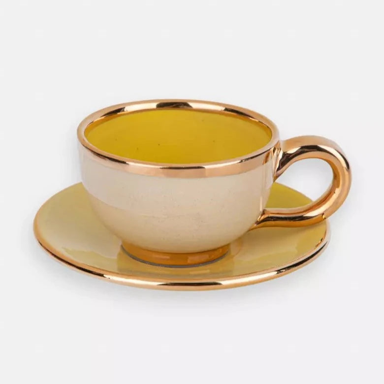 Ceramic cup and saucer with golden edge, yellow and beige. 