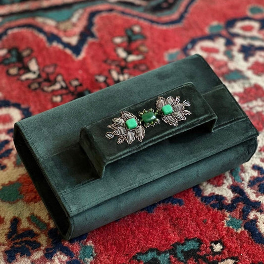 Dark green clutch with embroidery and beads.