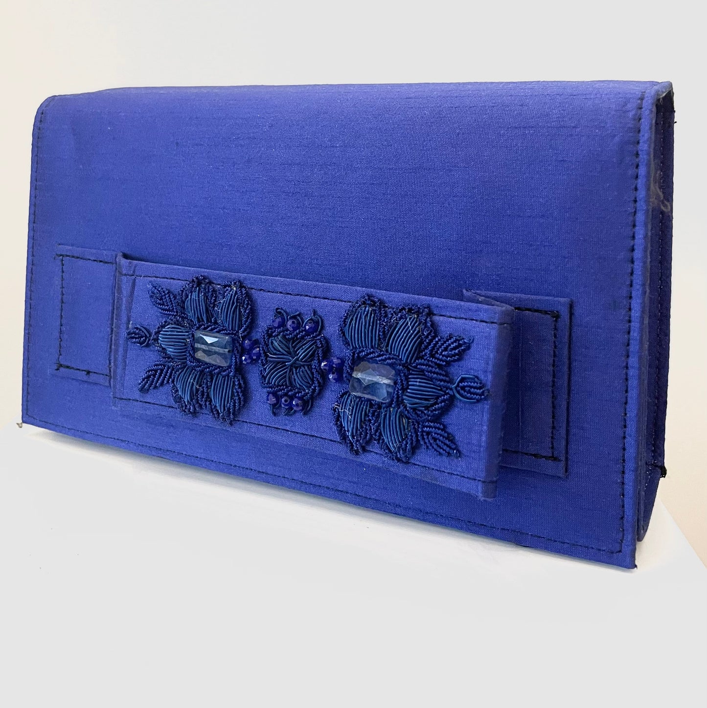 Dark blue clutch with embroidery and beads.