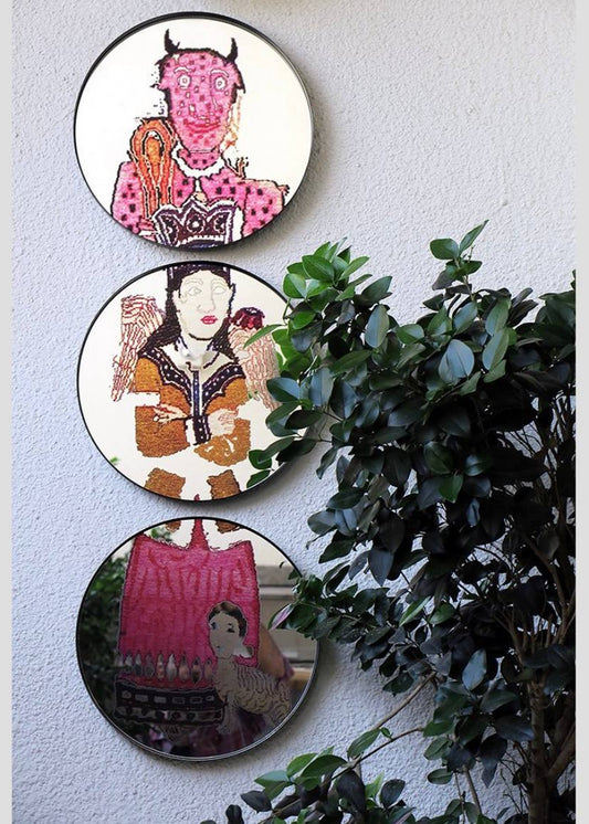 Circle mirror with metal frame and digital print on the wall.