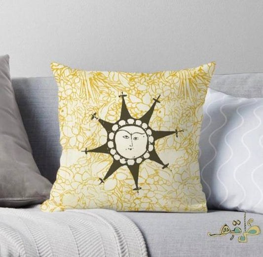 cushion with yellow floral pattern and abstract sun in the center.