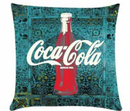 cushion with green pattern in background and Coca Cola design in center.
