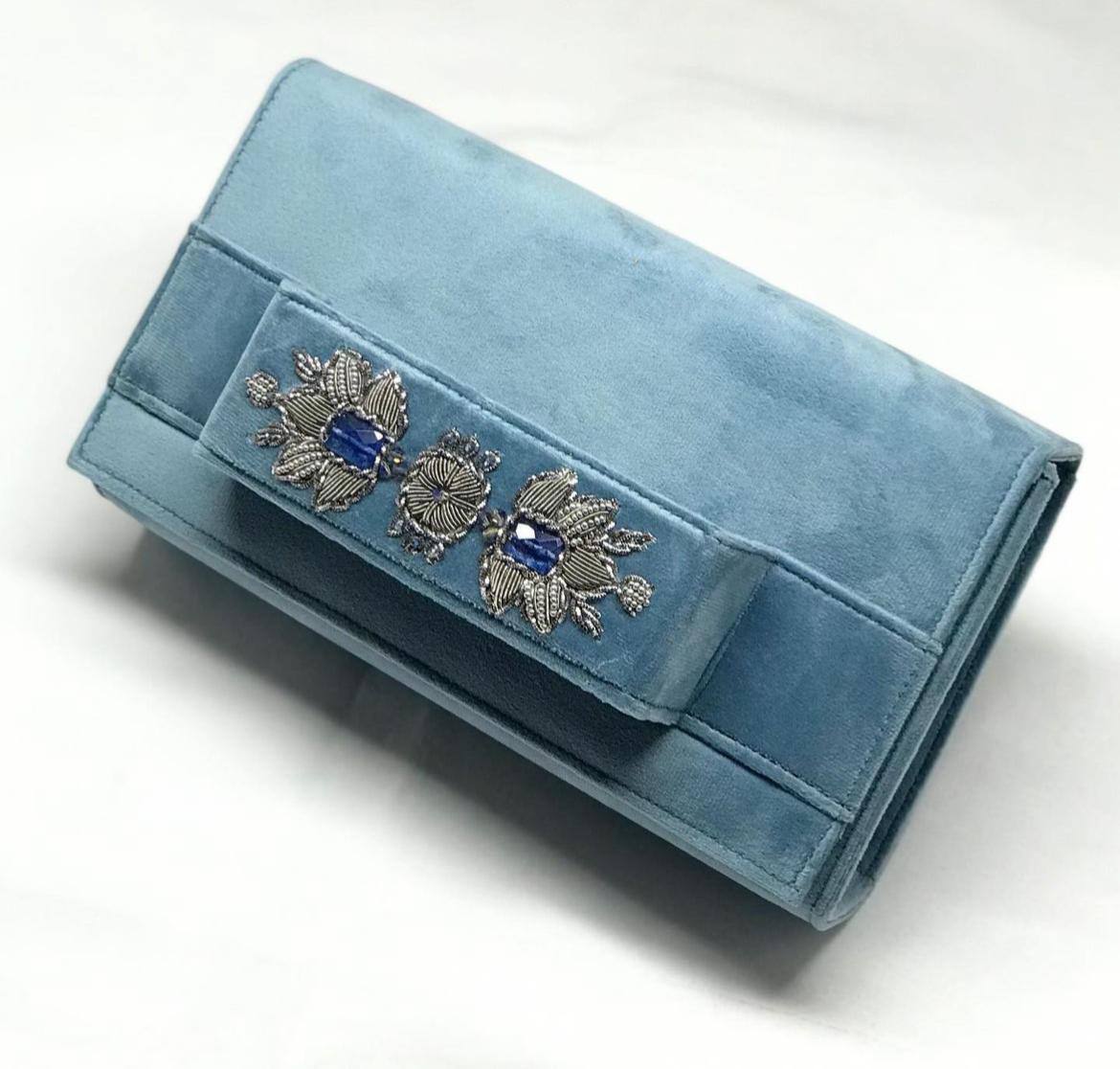 Light blue velvet clutch with embroidery and beads.